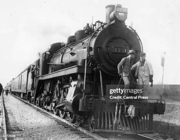 The Prince of Wales chatting to the engine driver on the cowcatcher of his locomotive, during the Prince's Canadian tour.