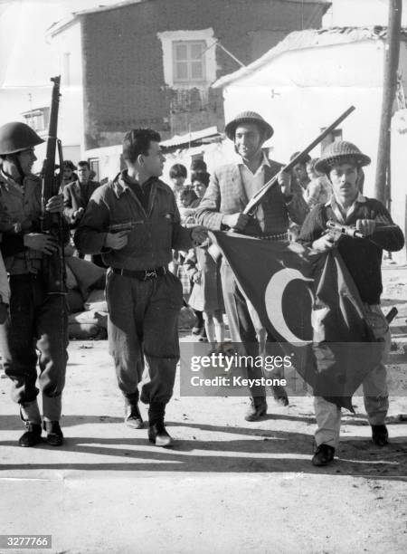 Former EOKA terrorist Nikos Sampson leads armed men with a captured Turkish flag after a Greek Cypriot coup. He later declared himself President.