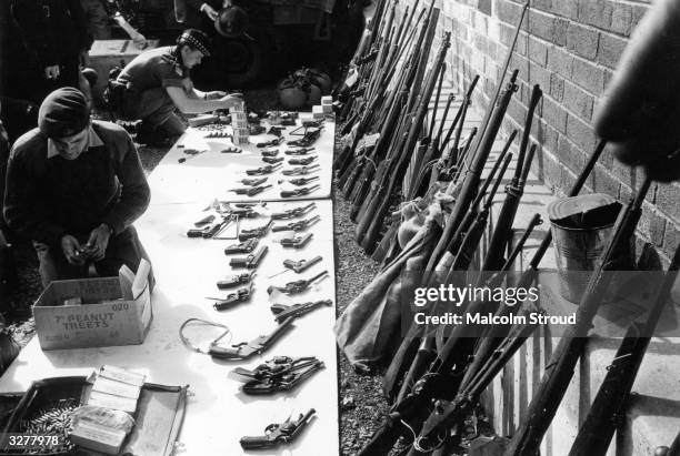 British soldiers sorting through a weapons cache in Belfast.