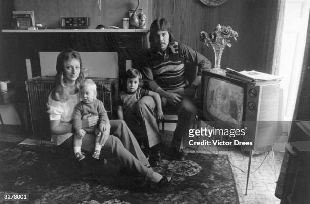 Mr Franklin with his wife and children in front of the TV in their Islington home.