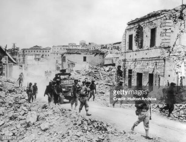 French troops of the 5th Army advance through the ruined streets of Portoferraic on the island of Elba.