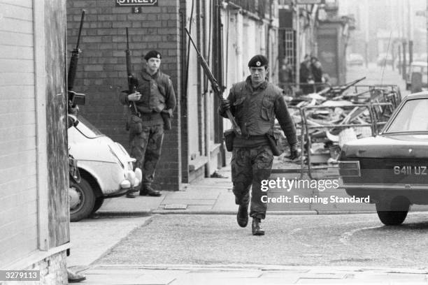 Armed British soldiers patrolling the streets of Belfast during the Official IRA's unconditional ceasefire.