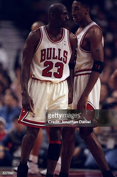 Michael Jordan bumps Scottie Pippen of the Chicago Bulls during the NBA Playoffs round 1 game against the Charlotte Hornets at the United Center in...