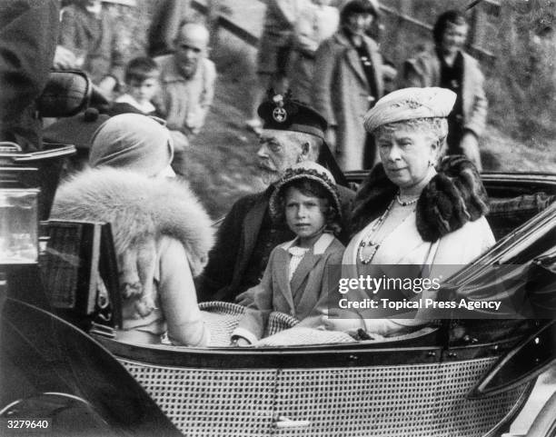 Princess Elizabeth of York with her grandparents, King George V and Queen Mary leaving a church service at Crathie in Aberdeenshire, Scotland. The...