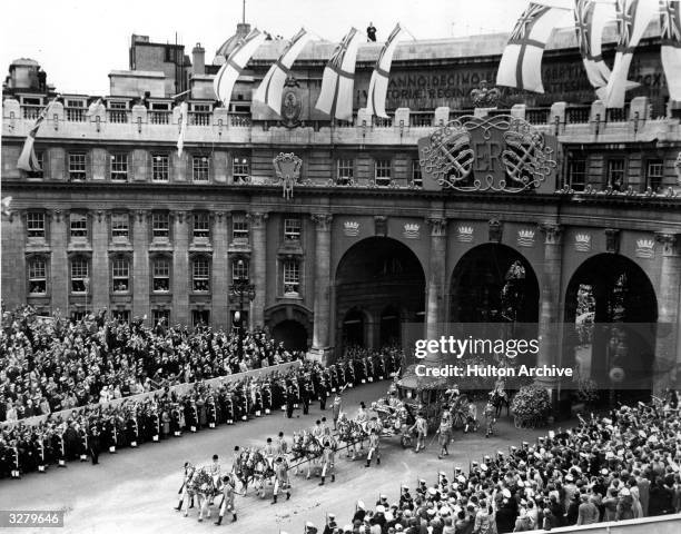 Queen Elizabeth II Coronation carriage and procession coming through Admiralty Arch on the way from Westminster Abbey to Buckingham Palace.