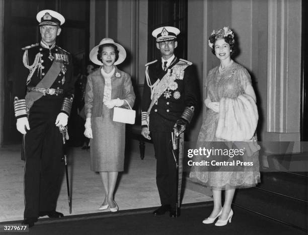 Queen Elizabeth and Prince Philip at Buckingham Palace with Queen Sirikit and King Bhumibol Adulyadej of Thailand, after the processional drive from...