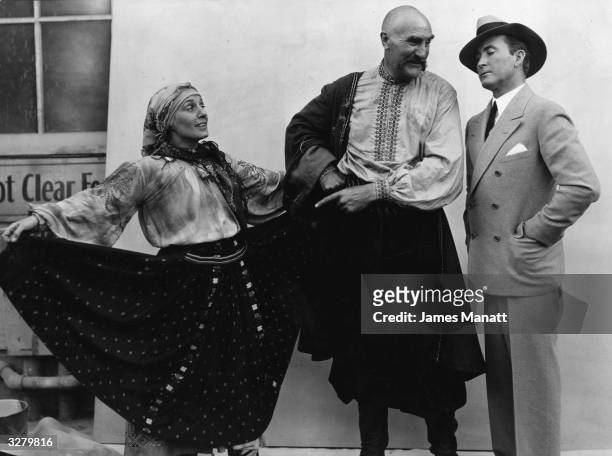 From left to right, actors Mary Alden , Ernest Torrence and Tim McCoy on the set of the MGM film 'The Cossacks', directed by George W Hill and...