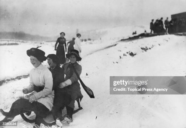 Girls tobogganing on the 'New Run' at Buxton.