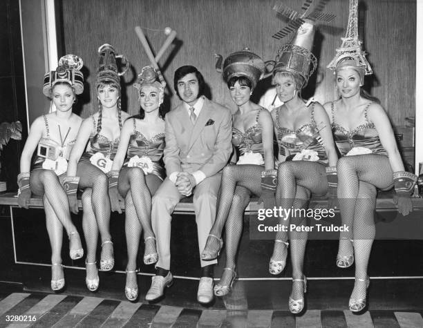 Singer Engelbert Humperdinck poses with The Strippers Of The Nation to help launch his new ATV television show. The Strippers are actually five of...