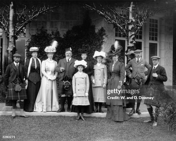 Royal family group on the steps of Mar Lodge. From left to right: Prince George, the Duchess of Fife, Queen Mary, Edward VII, Princess Maud of Fife ,...