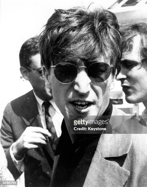 Beatles singer-songwriter, guitarist John Lennon arrives at Malaga in Spain for the continued shooting of Dick Lester's film 'How I Won The War', in...