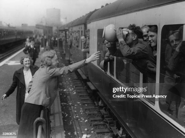 Long drink for a member of the BEF at the end of his journey home from Dunkirk.