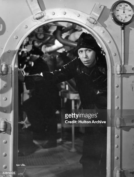 Sou'wester clad George Formby peers out of an engine room in a film which also stars Phyllis Calvert, Garry Marsh, Romney Brent, Bernard Lee, Coral...