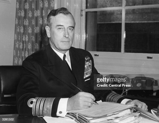 Admiral the Earl Mountbatten, as first Sea Lord, at his desk at the Admiralty office.