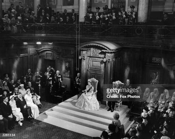 Queen Elizabeth II in her Coronation gown, with the Duke of Edinburgh, inside the Parliament House, Wellington, New Zealand during the State Opening...