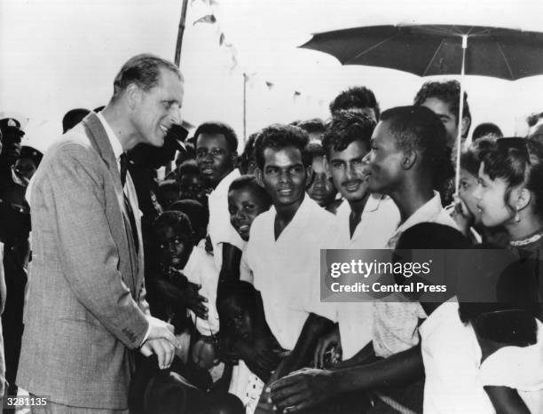 The Duke of Edinburgh talking to sugar estate workers on the occasion of his visit to British Guiana.