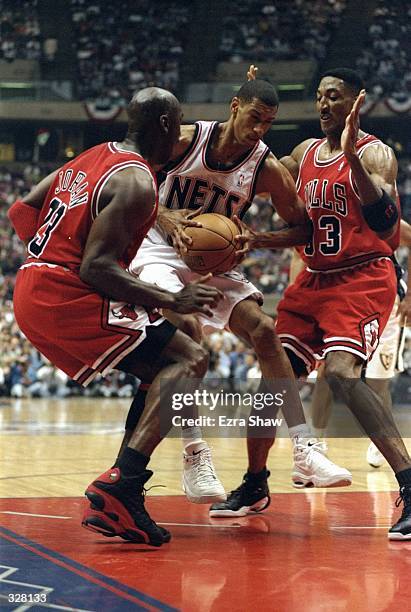 Kerry Kittles of the New Jersey Nets in action against Michael Jordan and Scottie Pippen of the Chicago Bulls during the NBA Playoffs round 3 game at...