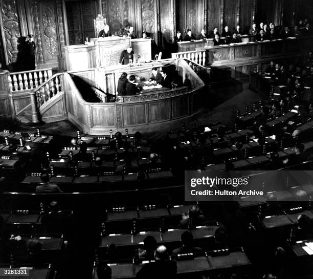 Photograph showing inside of the Imperial Diet with Shigeru Yoshida on the speakers platform with Kijuro Shidehara, president of the House of...