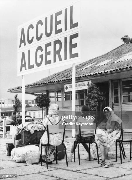 Muslim women wait at Orly Airport, near Paris, to return to Algeria where the referendum for self-determination will shortly take place. They are at...