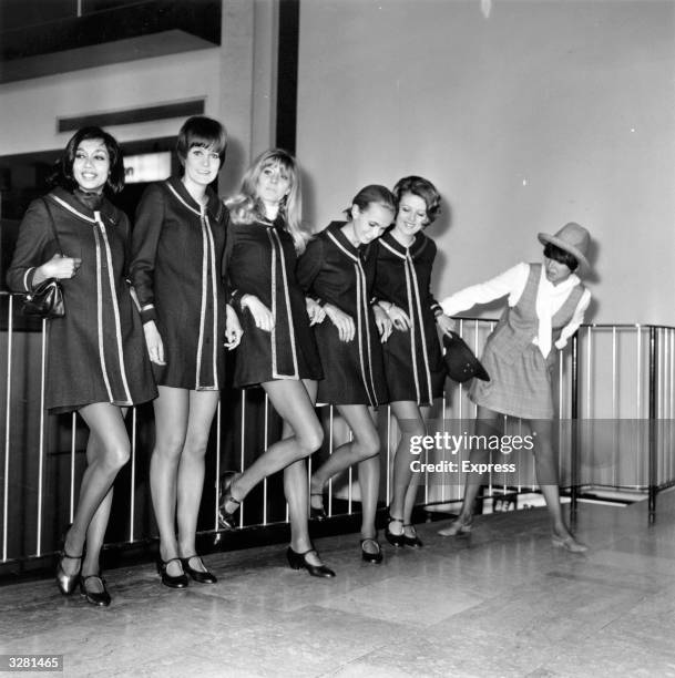 English fashion designer Mary Quant with a group of models at Heathrow Airport, before leaving for a continental fashion tour.