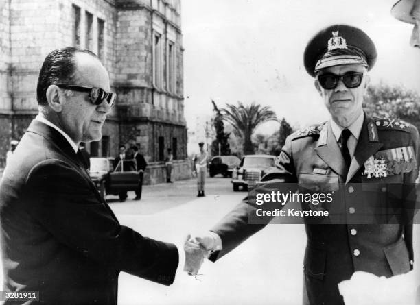 Greek premier George Papadopoulos shakes hands with Commander in Chief of the Greek Armed Forces General Odysseas Angelis.