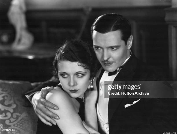 Rita La Roy is in the arms of Ivan Lebedeff the Russian character actor who came to America in 1925 and was a former diplomat. They appear in the...
