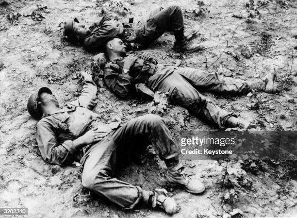 American troops resting on a Korean battlefield.