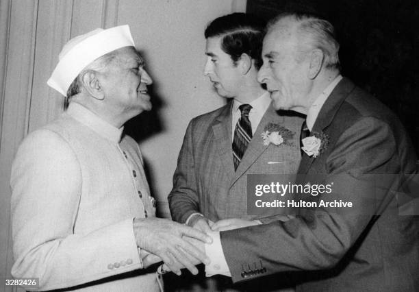 Charles, Prince of Wales and Lord Louis Mountbatten greeting a dignitary during a visit to Delhi to lay a wreath on Mahatma Gandhi's shrine.