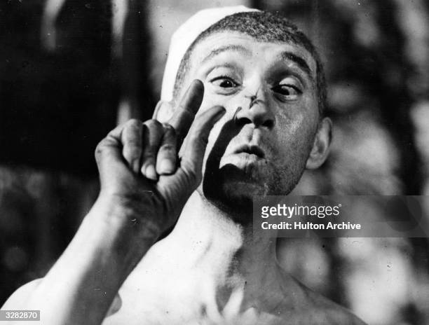 French actor Pierre Fresnay with a fly on his nose in a scene from 'Cheri-Bibi', directed by Leon Mathot for DPF.