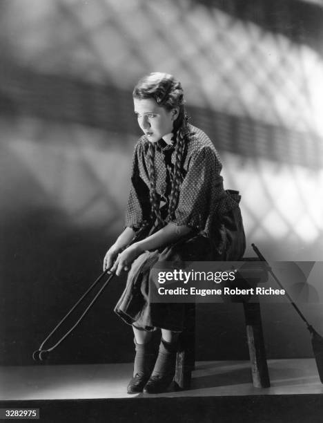 Jean Arthur the stage name of Gladys Greene, the American leading actress and Paramount player is sitting looking forlorn as the 'twelve o'clock...