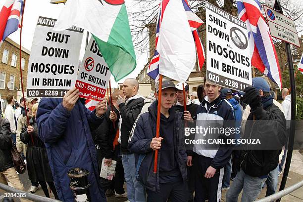 Young National Front Members protest at the Finsbury Park Mosque as Muslim cleric Abu Hamza speaks to his followers only metres away 09 April 2004....