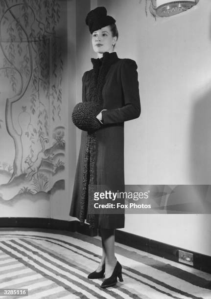 Portrait of a model at a fashion show organised by the Interntional Wool Secretariat at Claridge's Hotel London. She is modelling a black wool jersey...