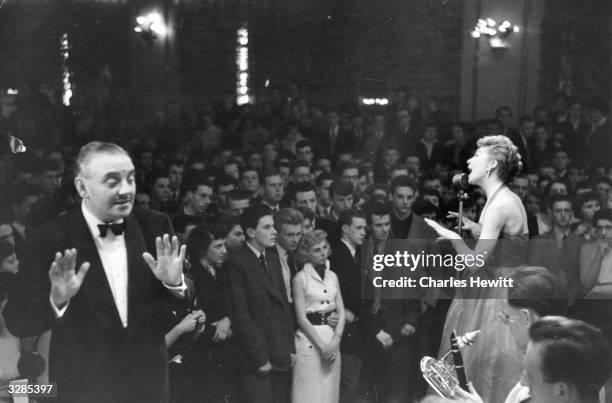 Ted Heath , conducting his band whilst Kathy Lloyd sings at the Wolverhampton Palais de Danse. Original Publication: Picture Post - 7178 - Ted Heath...