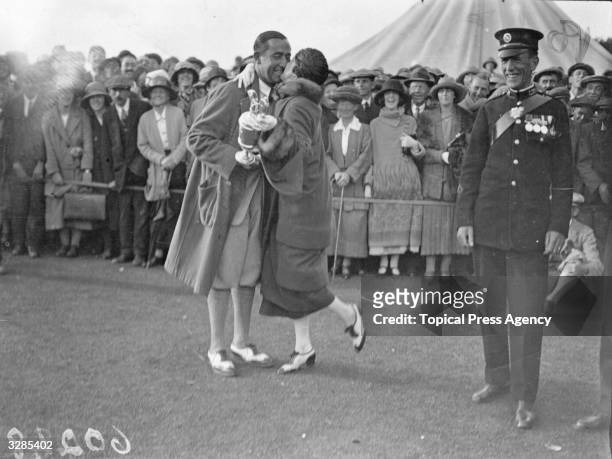 Walter Hagen , American winner of the Open Golf Championship at Hoylake, being congratulated by his wife.