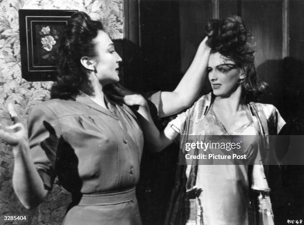 British actress Googie Withers, with Susan Shaw in a scene from the film 'It Always Rains On Sunday', directed by Robert Hamer for Ealing Studios....