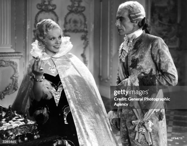 Hugh Miller and Gitta Alpar in a teasing scene from the film 'I Give My Heart', adapted from the operetta success 'The Dubarry' and directed by...