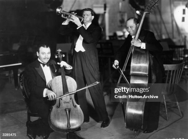 American director Alan Crosland makes music with Sigmund Romberg , and Oscar Hammerstein , who are responsible for the music for the Warner Brothers...