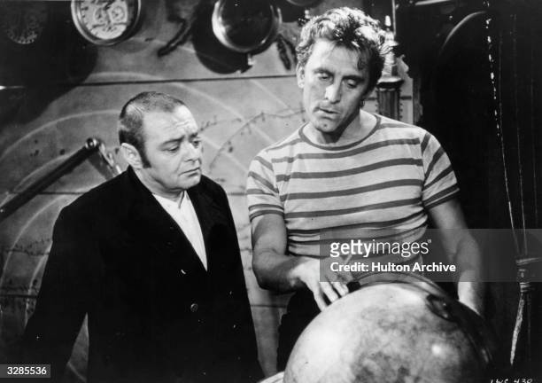 Kirk Douglas and Peter Lorre as Ned Land and Conseil in a scene from the film '20,000 Leagues Under The Sea', adapted from the novel by Jules Verne....
