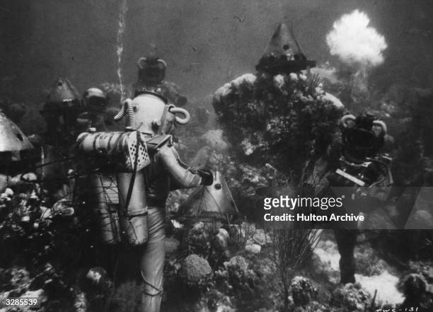 Divers from the submarine Nautilus harvest kelp and hunt fish in this scene from the film '20,000 Leagues Under The Sea', adapted from the novel by...