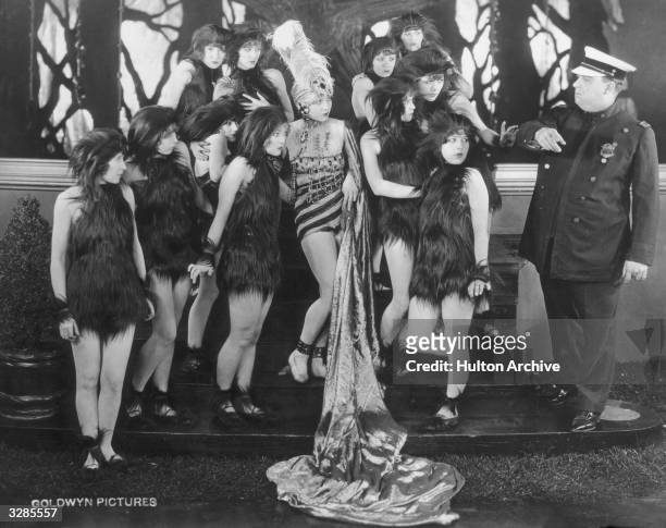 Group of women wearing skimpy fur outfits in a scene from the film 'D-Zug Des Grauens'.