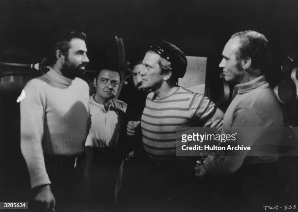James Mason in a scene from the film '20,000 Leagues Under The Sea', adapted from the novel by Jules Verne. With him are Kirk Douglas and Peter Lorre...