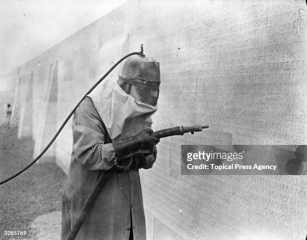 Sand blaster cutting the names of some of the 11,500 missing, on the Canadian National Vimy Memorial, near Vimy, Pas-de-Calais, France, circa 1935.