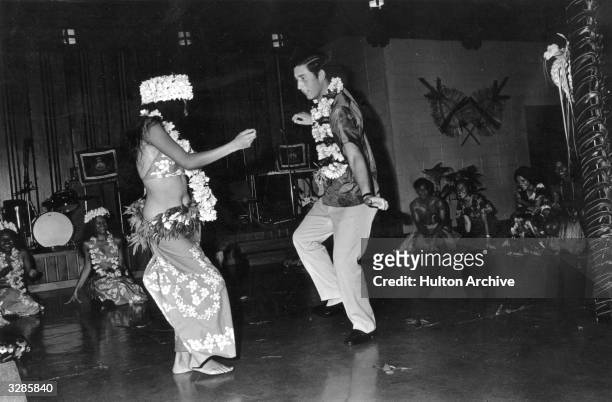 Charles, Prince of Wales dancing with a woman at a social function held in his honour during a Royal tour of Fiji.