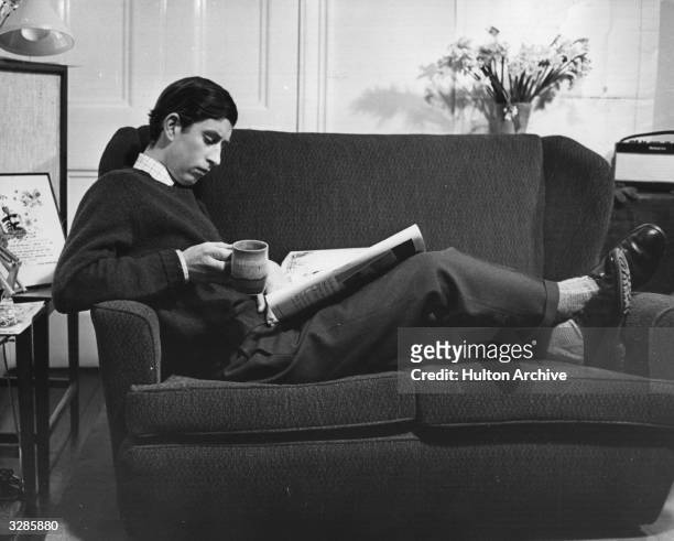 Charles, Prince of Wales relaxing in his study at Cambridge University.
