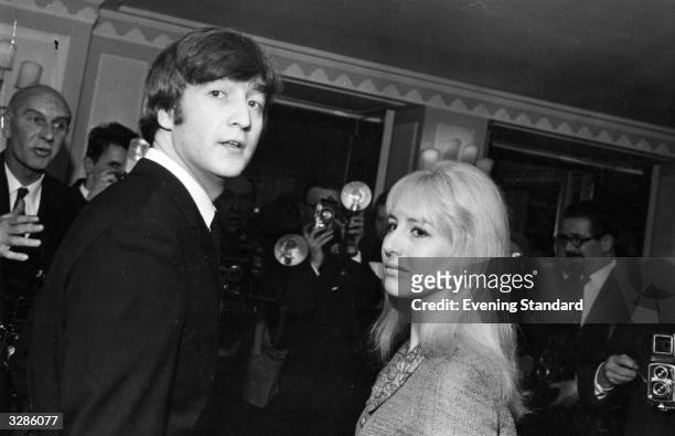 Singer-songwriter John Lennon of The Beatles, with his wife Cynthia at the Dorchester Hotel, London, for a Foyles Luncheon after the publication of...