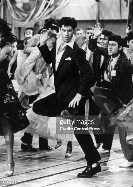 Singing and dancing, actor John Travolta struts his stuff in the hit musical film 'Grease', a romantic comedy set in the 1950's rock 'n' roll era, in...