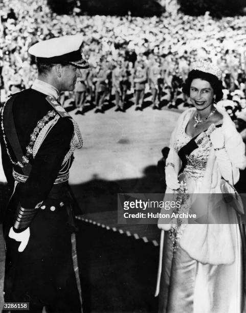 Queen Elizabeth and Prince Philip, Duke of Edinburgh on the steps of Parliament House, Wellington, New Zealand before opening the island's Parliament.