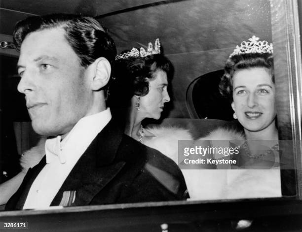 Angus Ogilvy, Princess Alexandra and Princess Marina leaving Kensington Palace in their limousine to attend a ball at Windsor Castle in their honour.