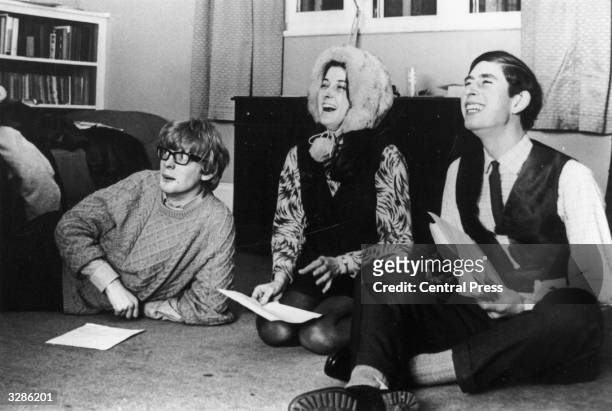 Charles, Prince of Wales reading through a play with his undergraduate friends whilst sitting on the floor of a Cambridge study.