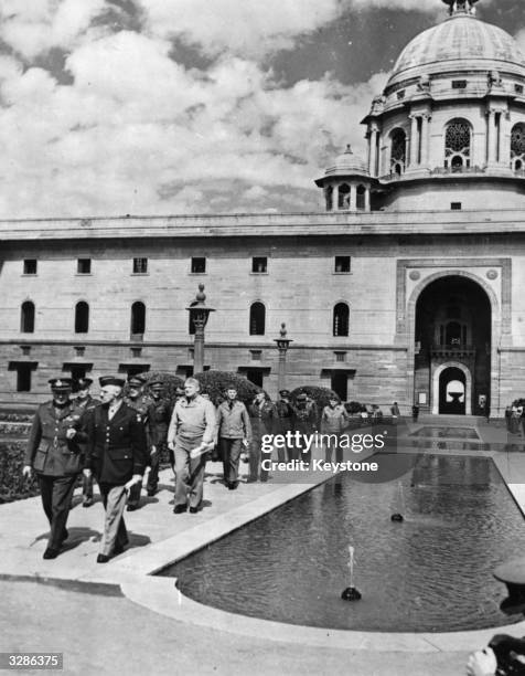 Officials from Britain and America walking away from the Imperial Secretarial Building in New Delhi, India where a staff conference was held. Field...